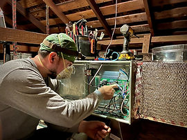 Pon Air And Heating technician servicing a heating unit